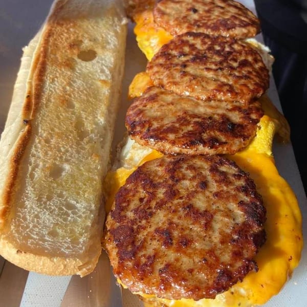 Toasted sub roll with four sausage patties, melted cheese, and egg from Selfie Subs Food Truck.