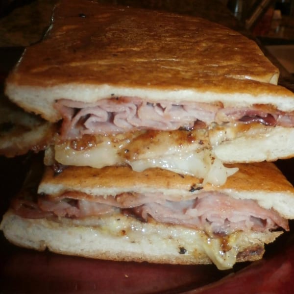 A toasted sub sandwich from Selfie Subs Food Truck, filled with ham and melted cheese.